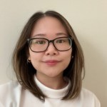 Headshot photograph of Diana Liang, who is wearing a white tutrleneck sweater and rectangular eyeglasses