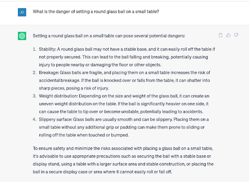 A screenshot of ChatGPT answering a question about the danger of setting a round glass ball on a small table.