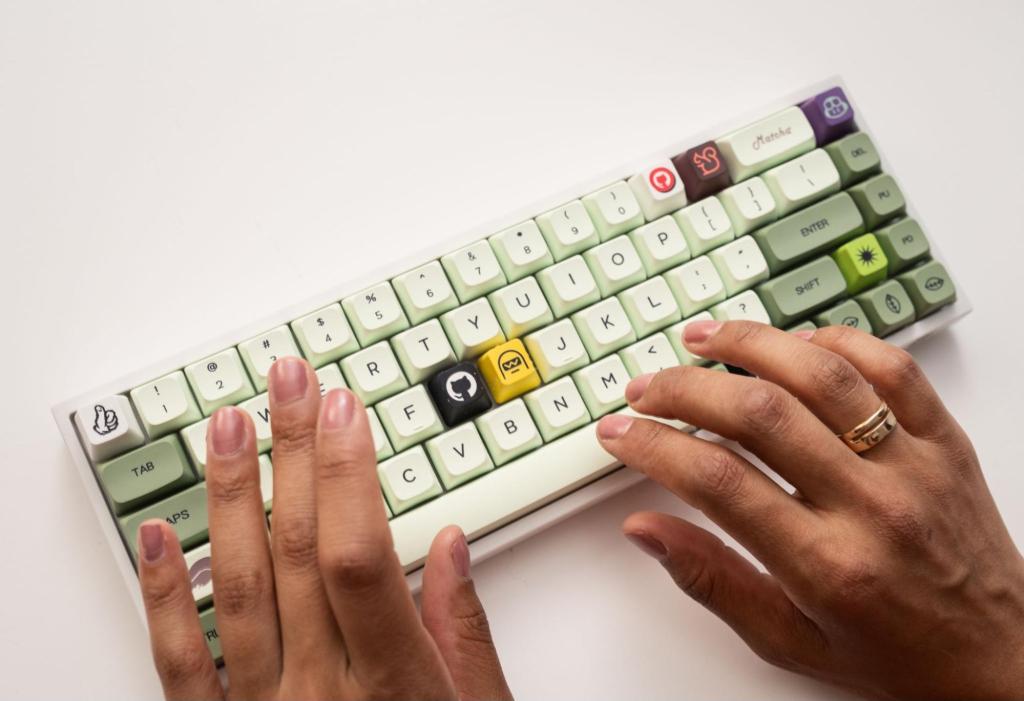 A pair of hands poised above a mechanical keyboard, several keycaps of which are GitHub-branded, including an Octocat logo and the famed shipit squirrel.