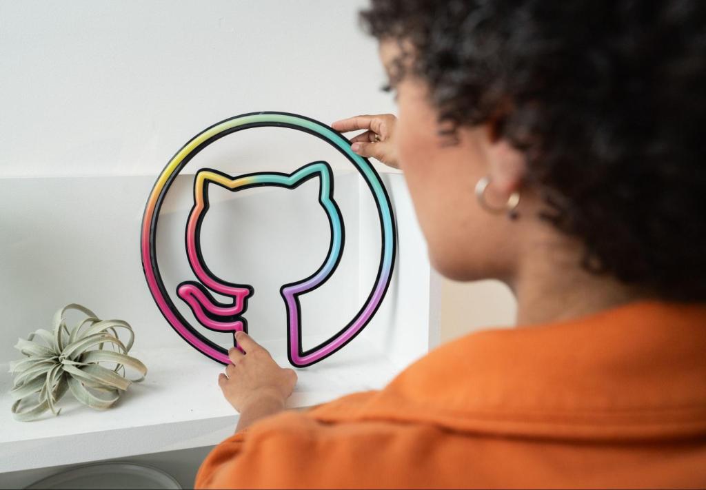 A woman straightens a rainbow colored Octocat light on the shelf where it is perched.