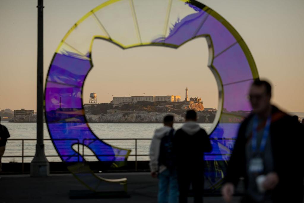 View of Alcatraz Island through a colorful art installation frame with visitors silhouetted at waterfront.