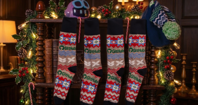 Four GitHub Ugly Holiday socks hanging on a shelf looking like stockings, the hat is hanging on the shelf too, and the amazeball is sitting on the shelf. The feeling is cosy and full of holiday cheer.