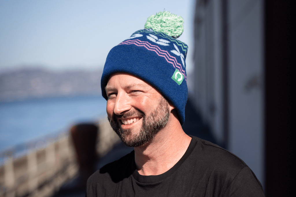 A model wears a GitHub-themed holiday beanie.