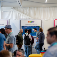 Photo of developers mingling at the Open Source Zone at GitHub Universe 2025.