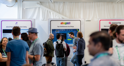 Photo of developers mingling at the Open Source Zone at GitHub Universe 2025.