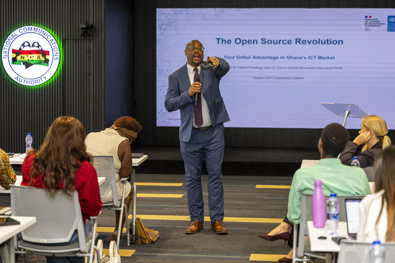 A speaker walks among the audience at the workshop.